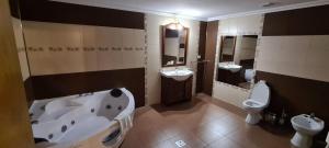 a bathroom with two sinks and a tub and a toilet at Poiana Rasnoavei in Râşnov +100 photos