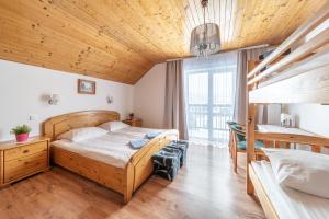 a bedroom with a bed and two bunk beds at Orchidea in Szklarska Poręba