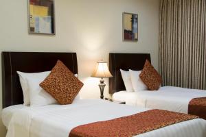 מיטה או מיטות בחדר ב-Al Rashid Residence