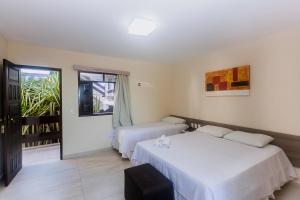 a hotel room with two beds and a window at Alimar Hotel in Natal +79 photos