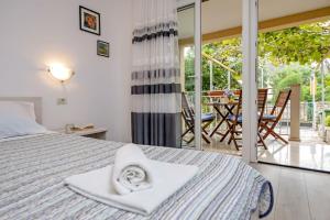 a bedroom with a bed with a towel on it at Apartments Pino in Rovinj