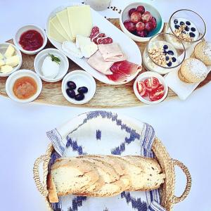 a table with bread and bowls of different foods at Vista de la Vila - Turismo de interior. in Llubí