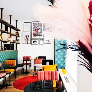 a restaurant with colorful chairs and tables in a room at Boutique Lodge Zandvoort in Zandvoort