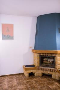 a living room with a fireplace and a blue wall at Pokoje Gościnne u Meresa in Żywiec