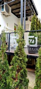 a group of trees in front of a building at Design Apartment PREMIUM SPA LUX 4 STAR "DUBAI" Completely PRIVATE Wellness & Spa FREE INCLUDED Sauna & Jacuzzi & Salt Wall & Fire place & 3D Ceilings & Business WiFi & NETFLIX & Keyless code entry & FULL SMART APP & SECURE 2 Parking place in Ćuprija