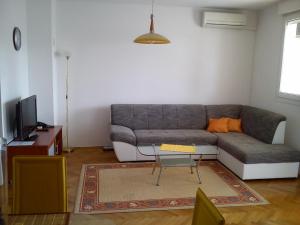 a living room with a couch and a tv at Zvijezda Mora Apartment in Split