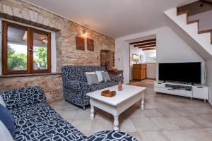 a living room with a couch and a tv at Holiday Apartment Daria 20 in Rovinj