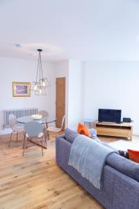 a living room with a couch and a table at Panmure Apartment in Monifieth