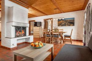 a living room with a fireplace and a table at Gästehaus Prugger by Schladmingurlaub in Ramsau am Dachstein