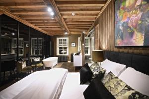 a bedroom with a white bed and a large painting on the wall at Small Luxury Boutique Hotel Wilma J in Vinkeveen