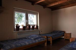 Łóżko lub łóżka w pokoju w obiekcie Pod Wiśnią Agroturystyka Kalwaria Pacławska