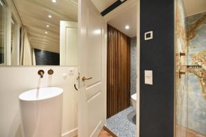 a bathroom with a sink and a toilet at Small Luxury Boutique Hotel Wilma J in Vinkeveen +63 photos
