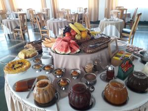 a table with a bunch of food on it at Hotel Escorial in Piriápolis