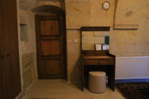 a room with a wooden desk and a wooden door at DIADEM CAPPADOCIA GUEST HOUSE & HOSTEL in Goreme