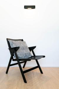 フェルデン・アム・ヴェルターゼーにあるAppartements Gästehaus Gallobの木製の床の上に座る黒い椅子