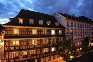 a large building with a black roof at Hôtel de l'Europe by HappyCulture in Strasbourg