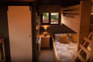 a small bedroom with a bed and a window at The Treehouse - Sleeps 4 in Old Leake