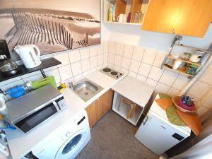 a small kitchen with a sink and a microwave at Global Downtown Apartments - Universitate - Calea Victoriei in Bucharest