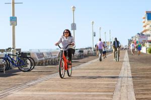 a person riding a bike on a dock at Dunes Manor Hotel & Dunes Suites in Ocean City