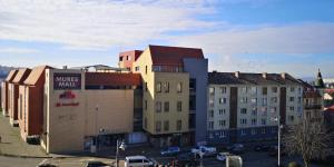 a group of buildings on a city street at Center Diamond in Târgu-Mureş