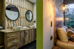 a bathroom with a large mirror and a sink at Los Patios Hostel in Medellín