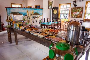 a buffet with many different types of food on a table at Pousada Chafariz das 4 Estações in Tiradentes