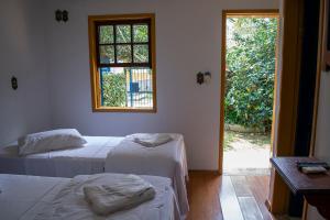 Кровать или кровати в номере Pousada Chafariz das 4 Estações
