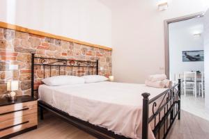 a bedroom with a large bed with a brick wall at Casa Marisol in Pula