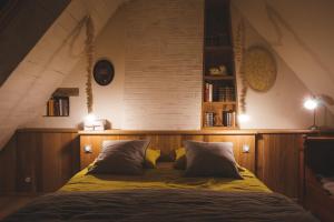 a bedroom with a large bed in an attic at Chambres d'hôtes de charme - Gîtes cosy - LA CLE DES CHAMPS - A la campagne in Martigné-Ferchaud