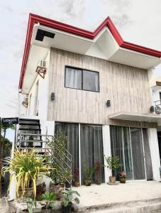 a house with plants in front of it at Best studio flat w/ NETFLIX near airport and beach! in Mactan
