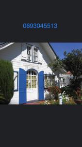 ein weißes und blaues Haus mit Garage in der Unterkunft LE CALBANON in Cilaos