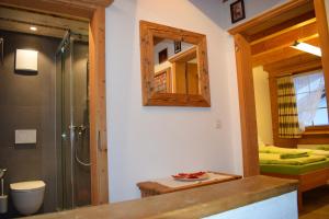 a bathroom with a shower and a sink and a mirror at B&B Stiffler-Huus in Davos +111 photos