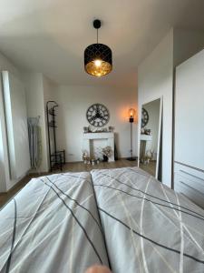 a room with a bed and a clock on the wall at Joanna Apartment - MA Rheinau in Mannheim