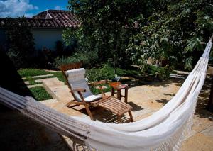 a hammock and a chair in a garden at La Nube Posada in Barichara