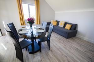 a dining room with a table and a couch at Holllie View in Killyhevlin