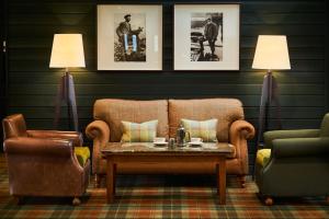 a living room filled with furniture and a lamp at Isle Of Mull Hotel and Spa in Craignure