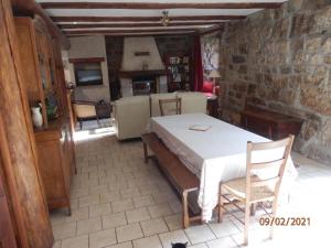 a bedroom with a bed and a stone wall at GITE LES MYOSOTIS in Le Chambon-sur-Lignon