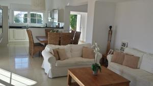 a living room with a white couch and a table at Villa Perla Blanca in Sayalonga