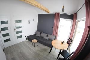 a living room with a couch and a table at Domek na Wzgórzu in Orelec