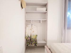a room with a closet with a dress in it at Villaggio Camping Oasi in Vieste