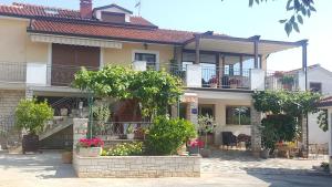 a large house with balconies and trees and plants at Haus Roko in Rovinj