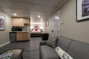 a living room with a couch and a kitchen at The Cache Hotel and Lodgings in Golden