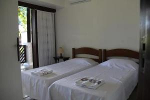 Katil atau katil-katil dalam bilik di Apartamento na Praia do Forte - Solar Garcia D'Ávila