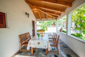 a table and chairs on the porch of a house at Haus Roko in Rovinj