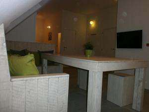 a table in a living room with a couch at 't Vossenerf in De Haan