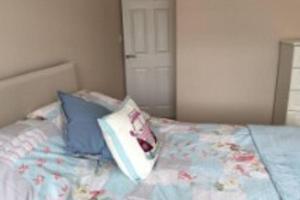 a bed with two pillows on top of it at BROOK COTTAGE in Whitstable