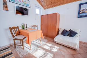 a dining room with a table and a bed at Haus Roko in Rovinj