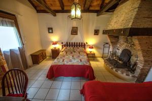a bedroom with a bed and a stone fireplace at LE GAHOUN - Chambres d'hôtes in Castets