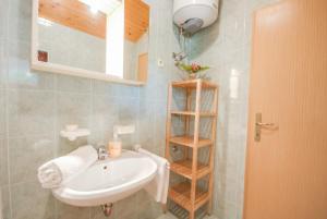a bathroom with a white sink and a shelf at Haus Roko in Rovinj +84 photos