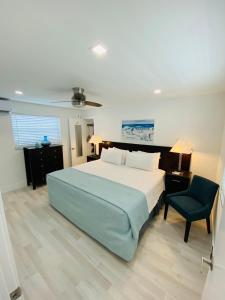 a bedroom with a large bed and a chair at Blue Sky in Hollywood